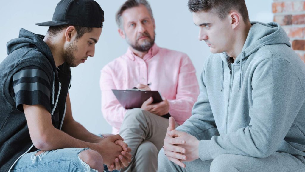 two men talking to a doctor about risks from codine overdose